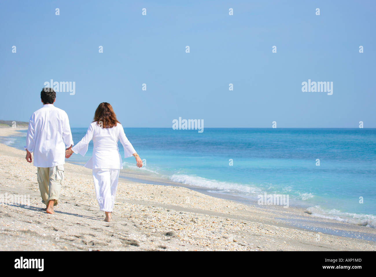 Couple walking on beach Stock Photo