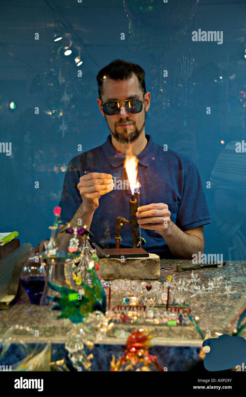 Glass blowing artist displaying his craftsmanship in a store Helen