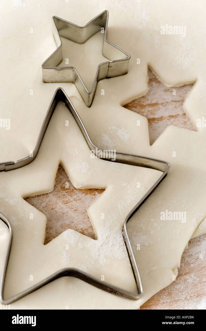 Raw pastry with star shaped cookie cutters Stock Photo