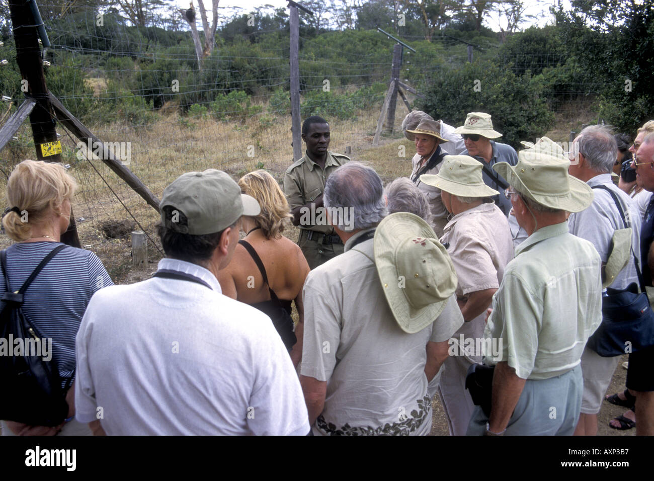 Tourist being given talk by African guide at the Sweetwaters Chimpanzee Sanctuary Kenya East Africa Stock Photo