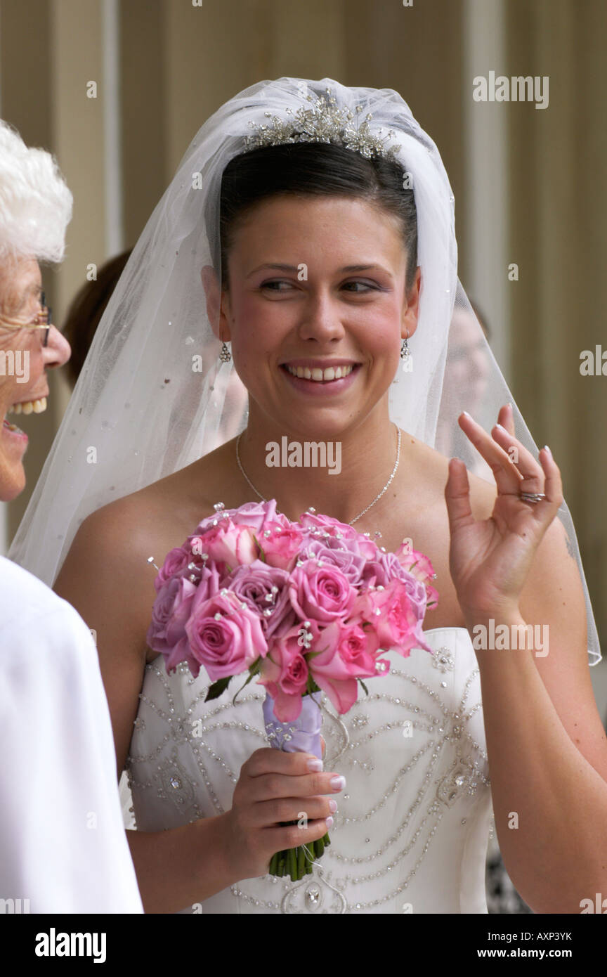 Bride posing with wedding bouquet Stock Photo - Alamy