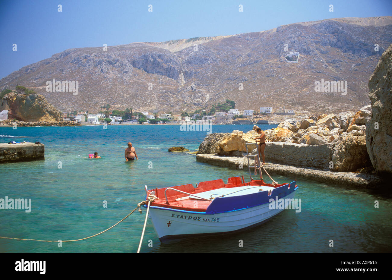 Locals relax by fishing boat Kalymnos Greece Stock Photo Alamy