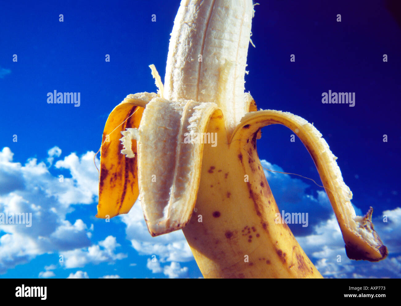 Half peeled banana with sky background Stock Photo - Alamy