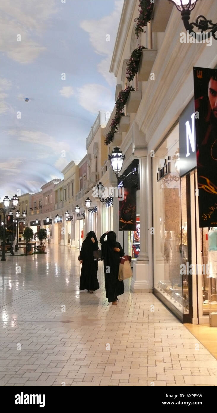 Local women wearing abayas shopping in Villaggio Mall, Doha, Qatar. Stock Photo