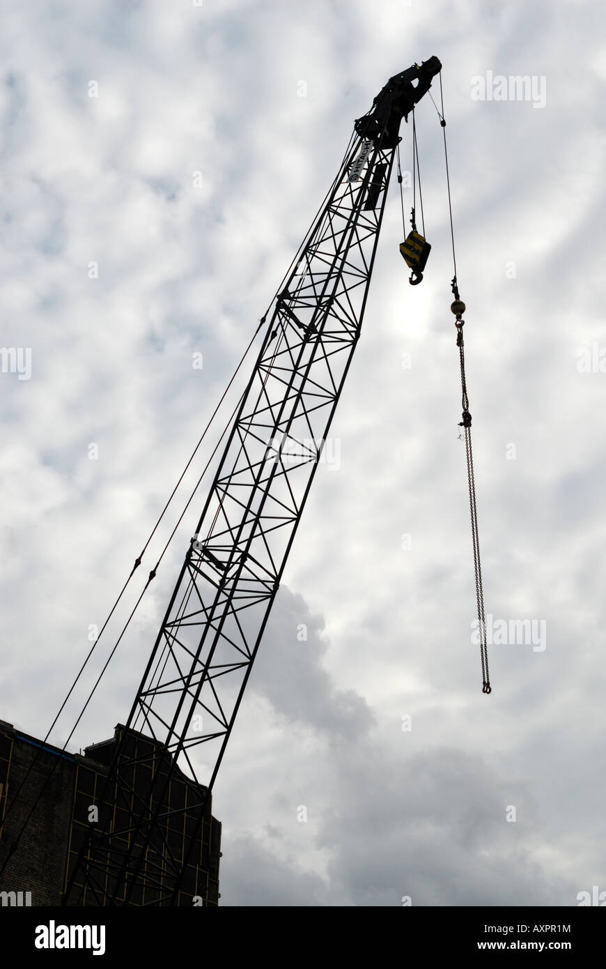 silhouette of a construction crane with a cloudy sky Stock Photo - Alamy