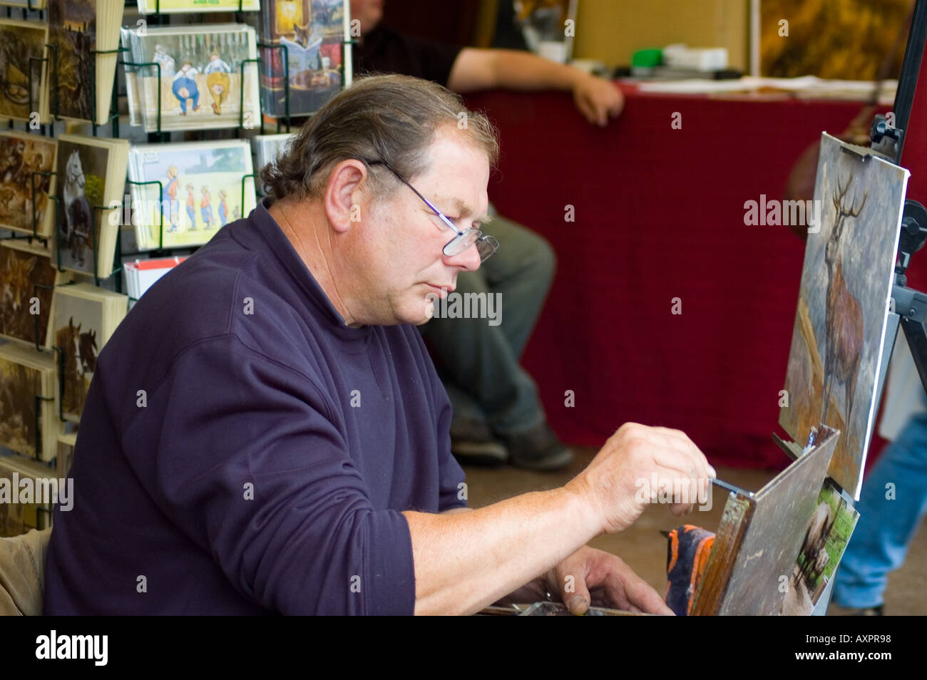 Man painting a picture on an easel Stock Photo - Alamy