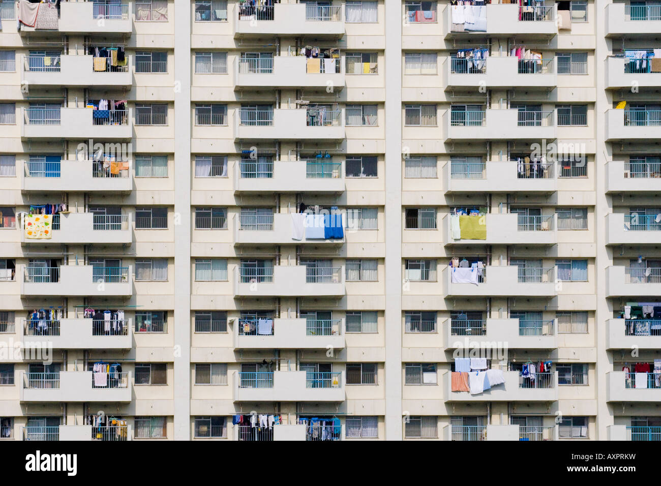 Laundry hanging out to dry over balcony railings in an apartment building in Tokyo Japan Stock