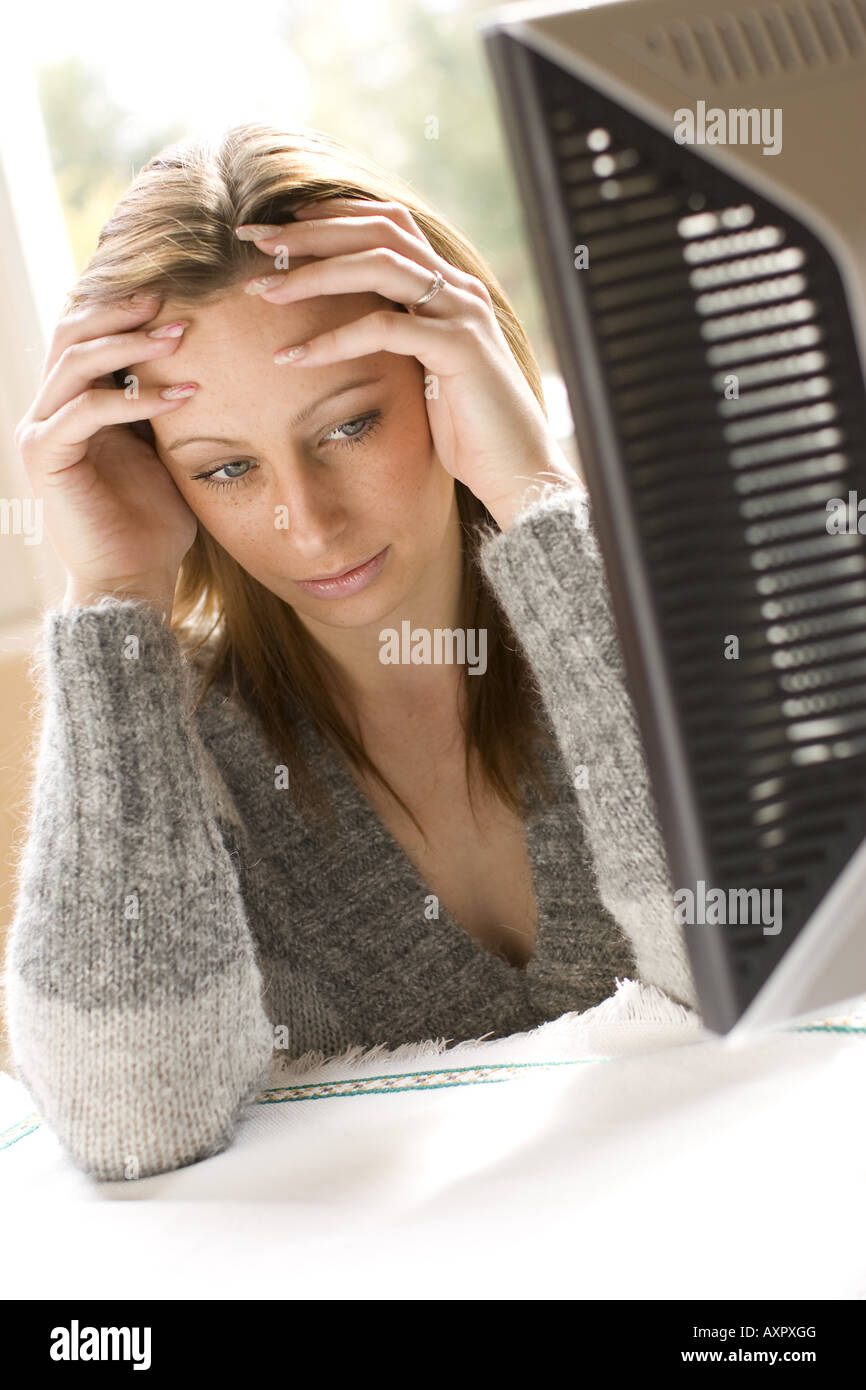 Frustrated woman using computer Stock Photo