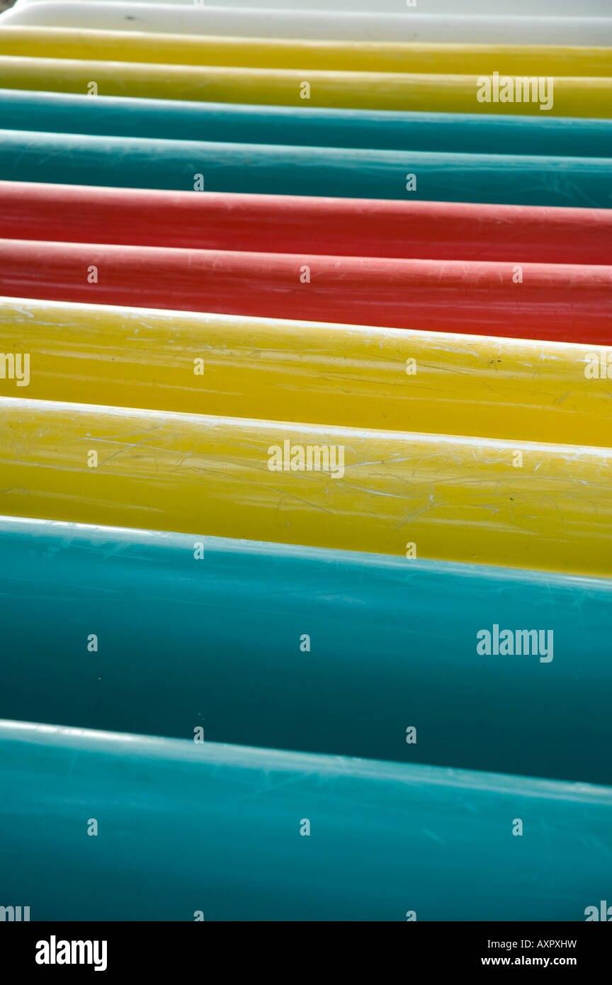 Colored canoes on a rack on Sepa Island. Stock Photo