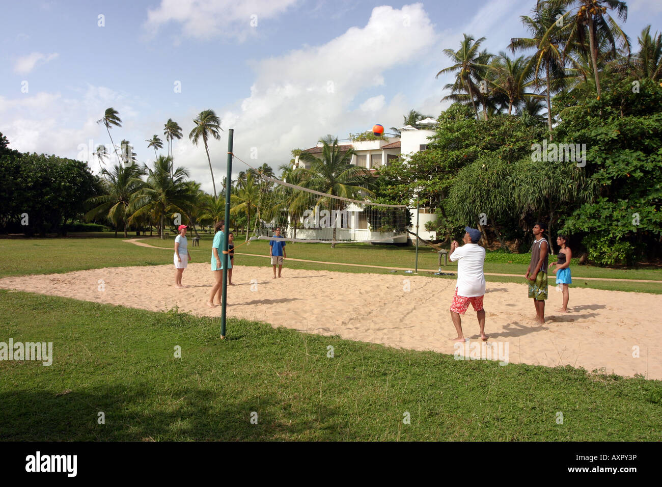 Sri Lanka holiday People, hotel guests, playing beach volleyball at