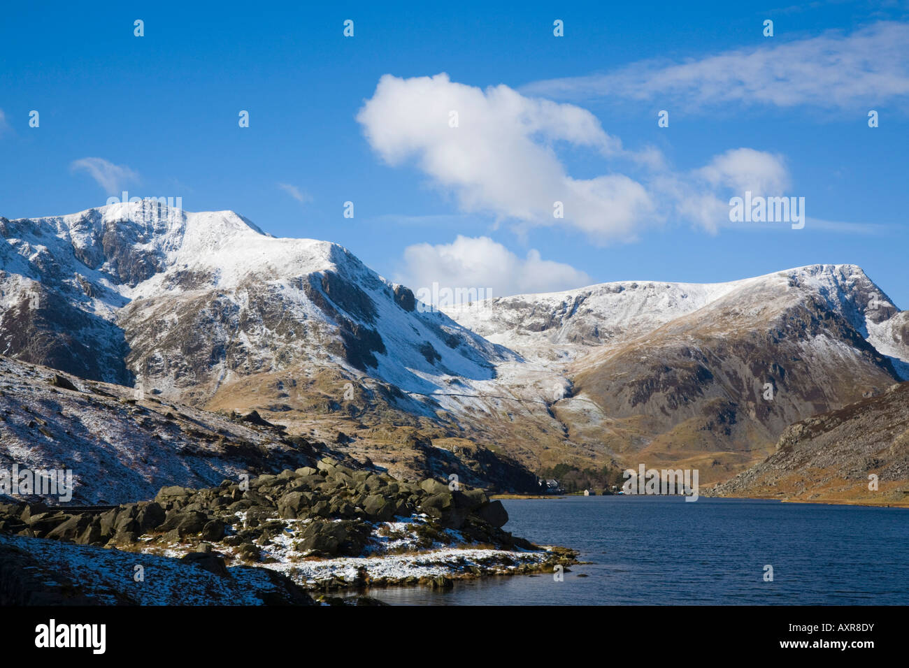 Snow capped Y Garn mountain across Llyn Ogwen lake in Snowdonia