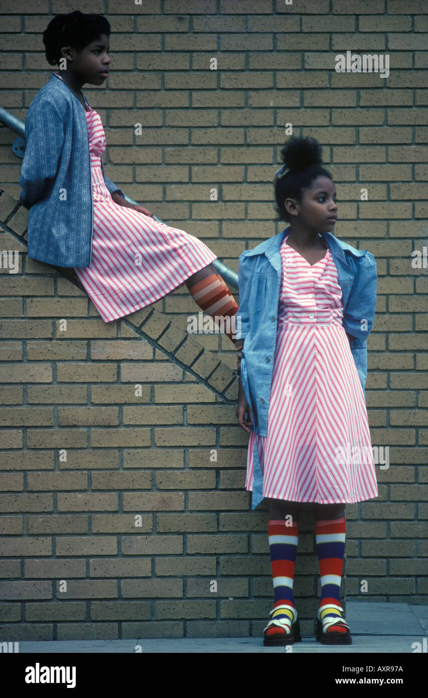 Young black British girls in similar clothes, looking fashionable Notting Hill west London England 1970s UK HOMER SYKES Stock Photo