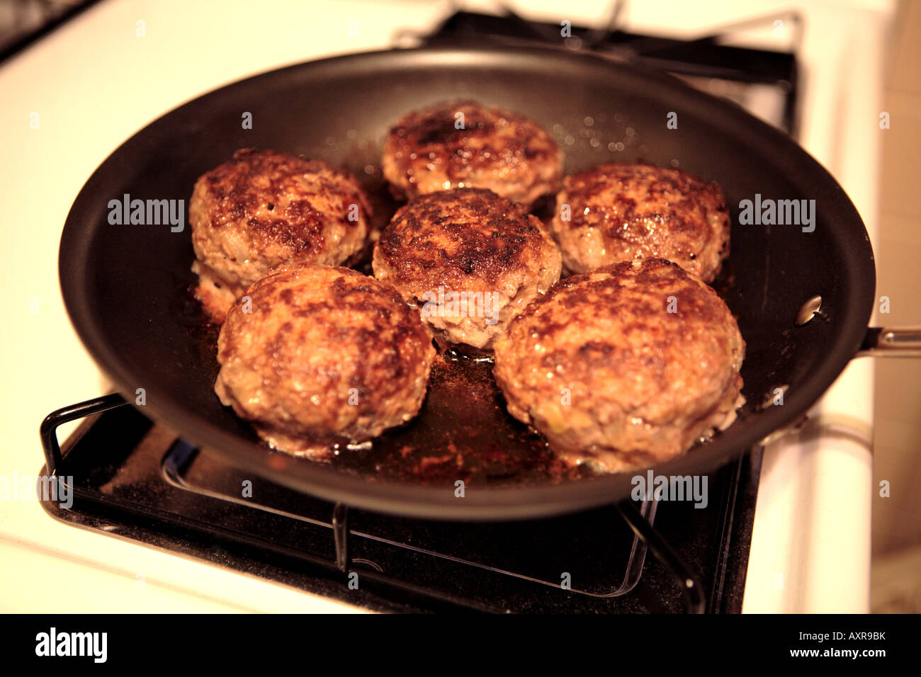 BEEF BURGERS FRYING ON A PAN Stock Photo Alamy