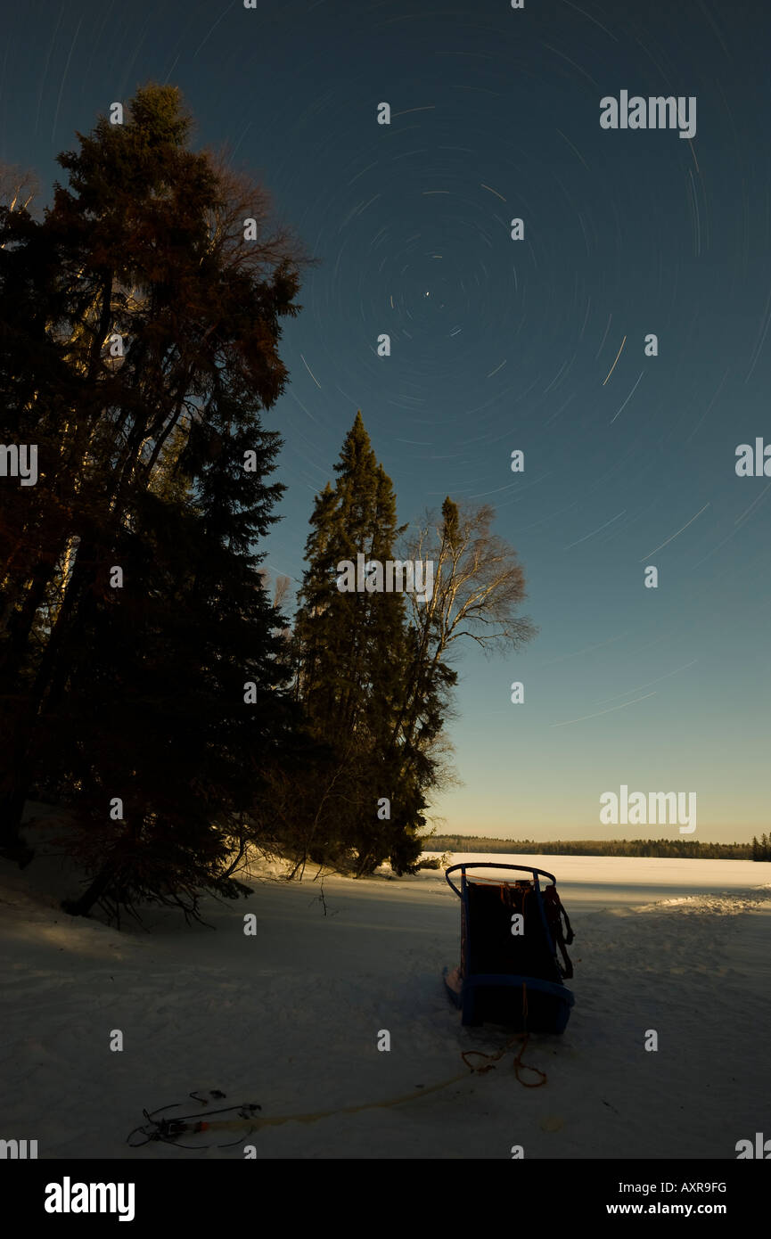 STAR MOVEMENT OVER A FROZEN LAKE AND DOGSLED BOUNDARY WATERS CANOE AREA MINNESOTA Stock Photo