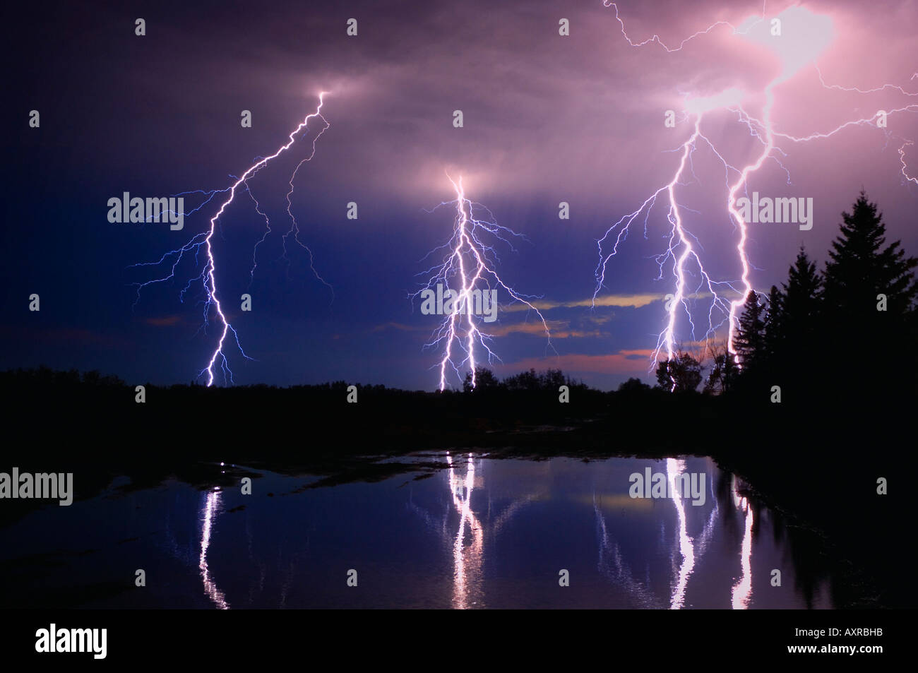 Lightning storm over a lake Stock Photo