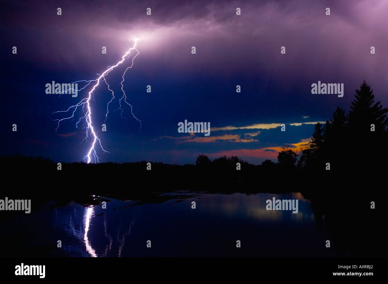 Lightning storm over a lake Stock Photo