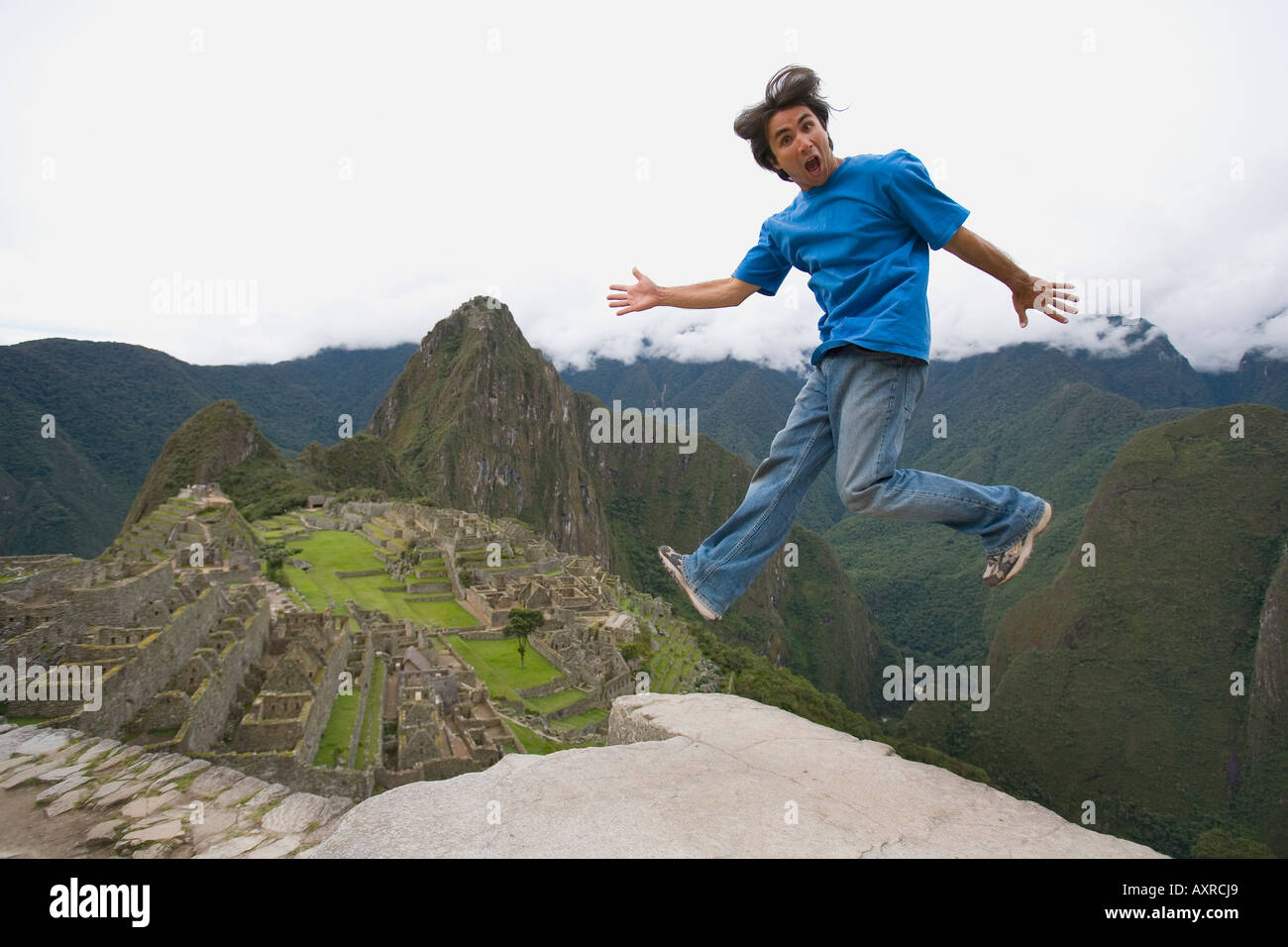 Peru Jumping Rocks Machu Picchu Peru; Man jumping near a pre-Columbian Inca site built ...