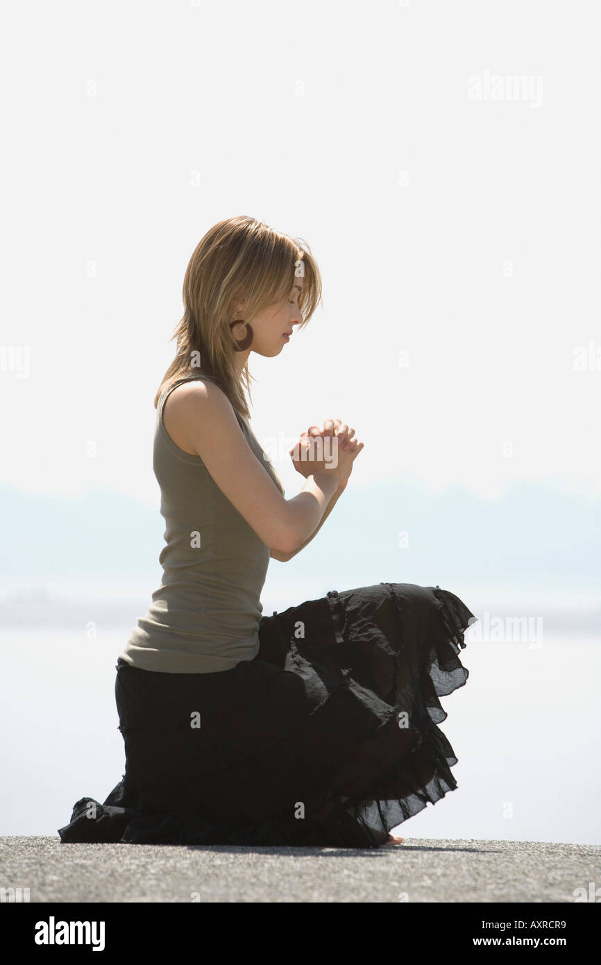 Teenager kneeling in prayer hi-res stock photography and images - Alamy