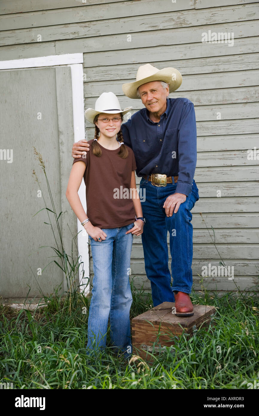 Grandfather and granddaughter wearing cowboy hats Stock Photo