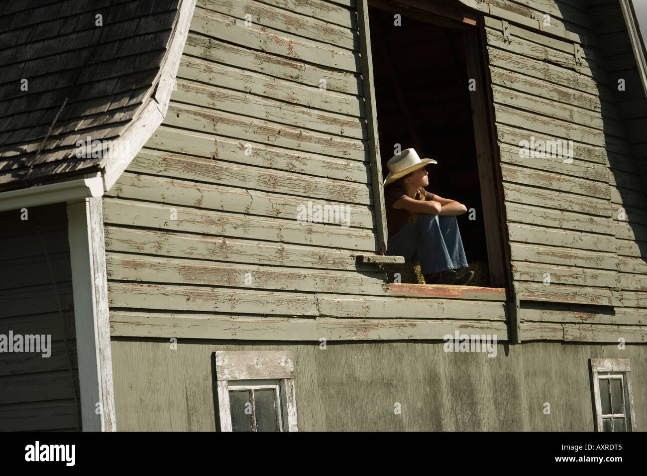 Young woman in barn loft Stock Photo - Alamy