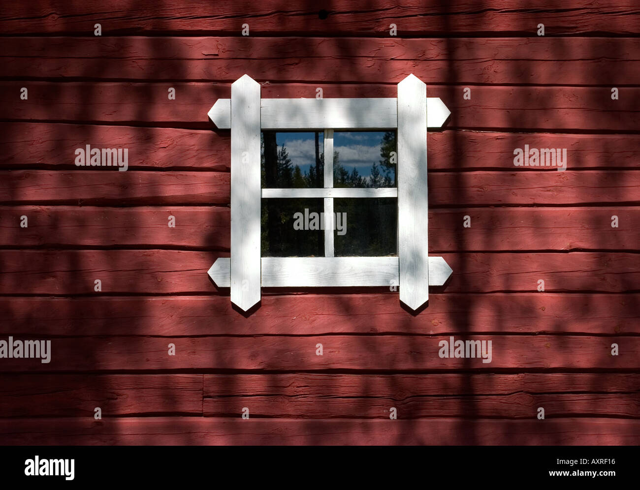 Old log cabin wall painted with red ochre paint and a small window , Finland Stock Photo