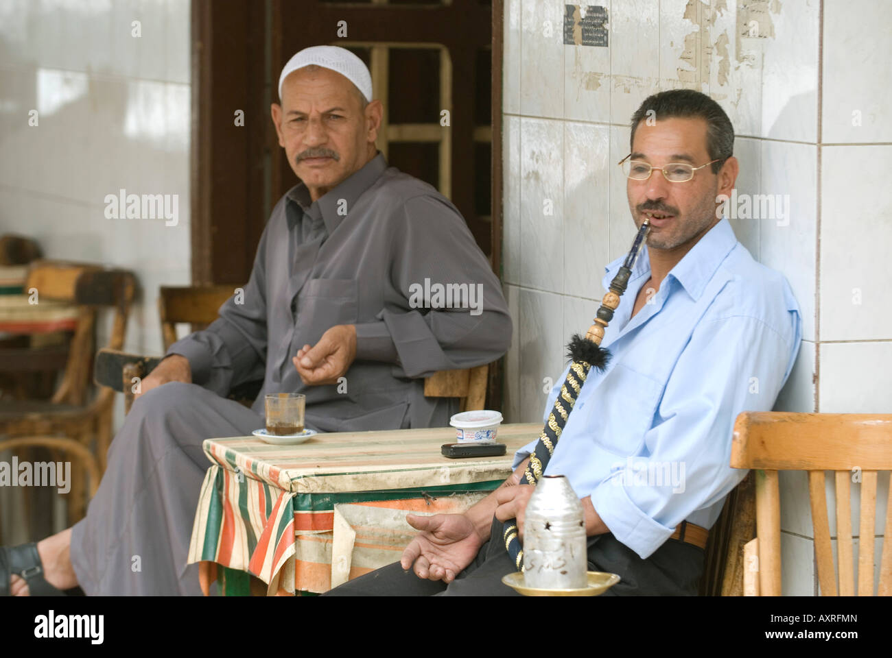 Man Smoking water pipe in Isamailia Egypt coffee shop street side cafe Stock Photo