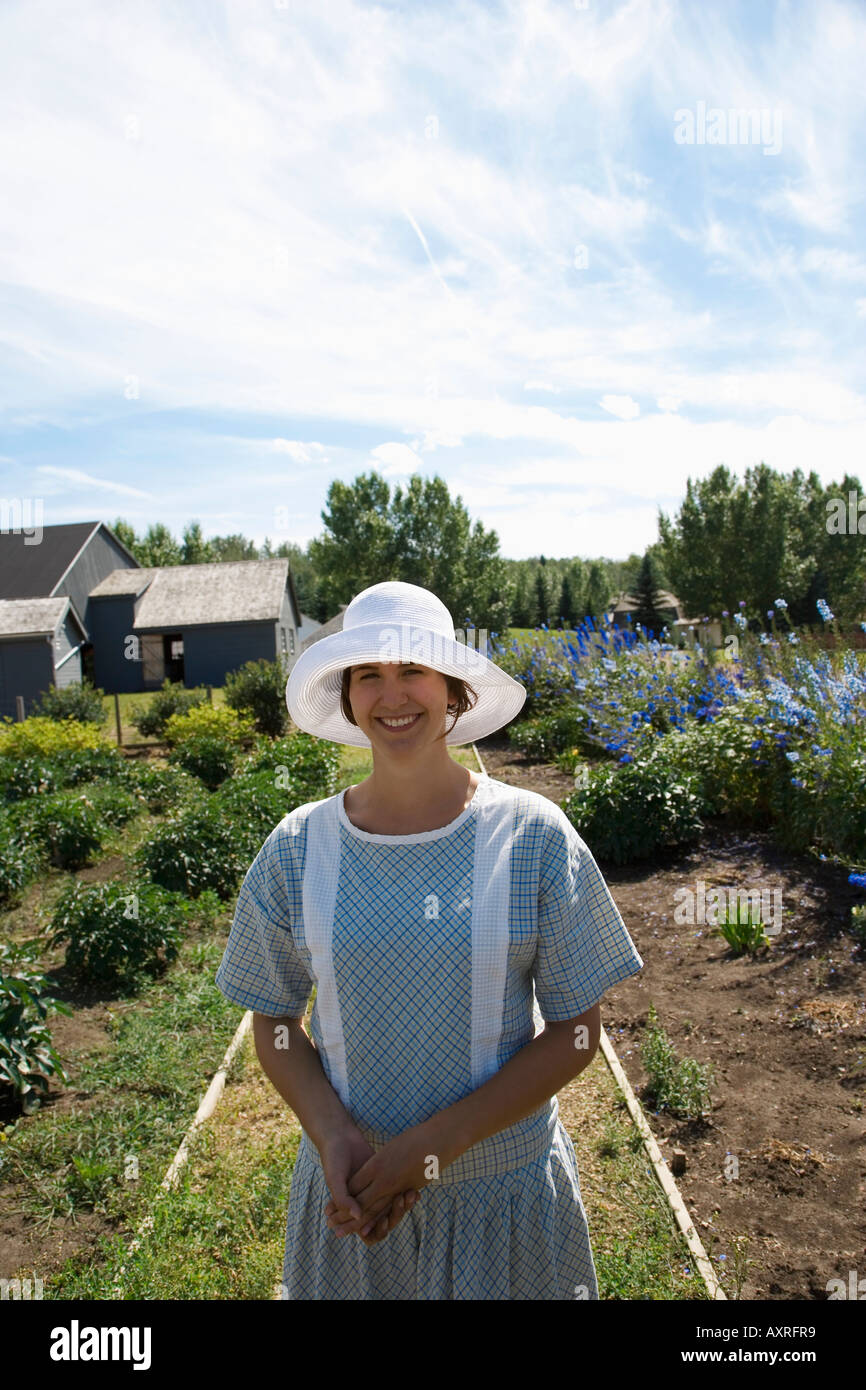 Woman in old fashioned clothing standing in garden Stock Photo - Alamy