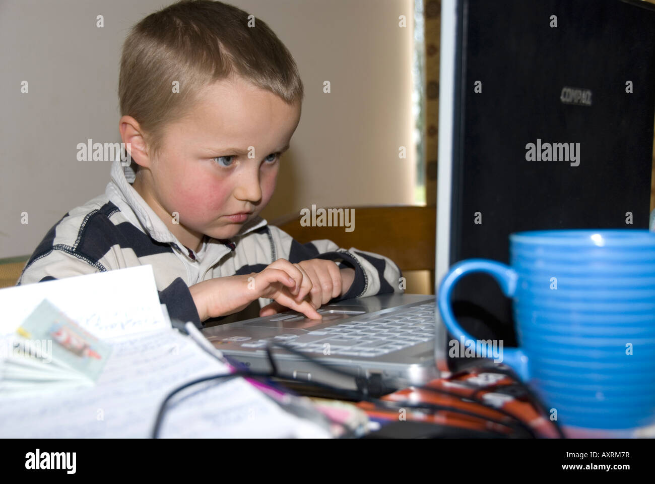Stock photo of an eight year old boy playing computer games on the ...