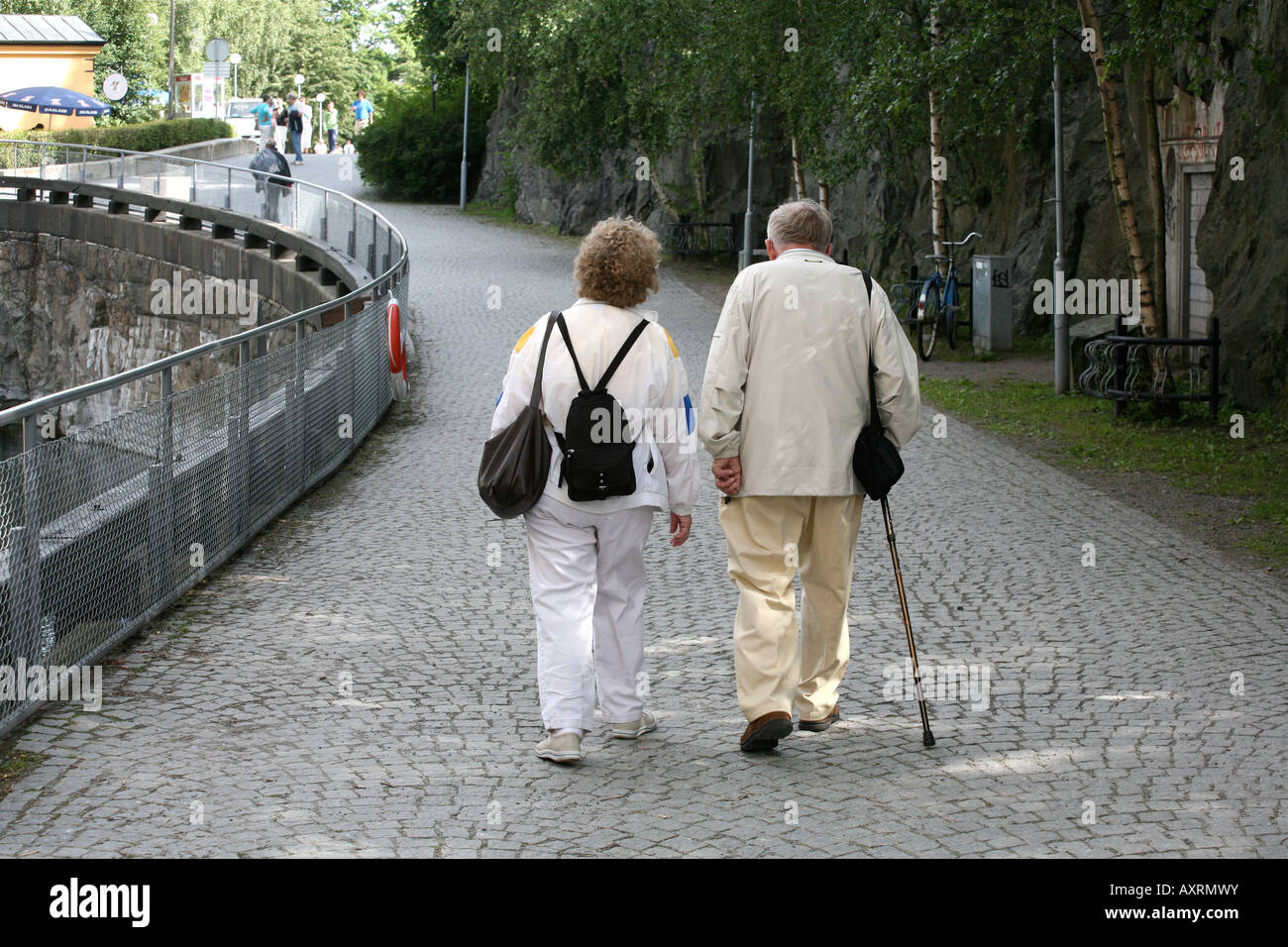 Couple walking down path hand in hand hi-res stock photography and ...