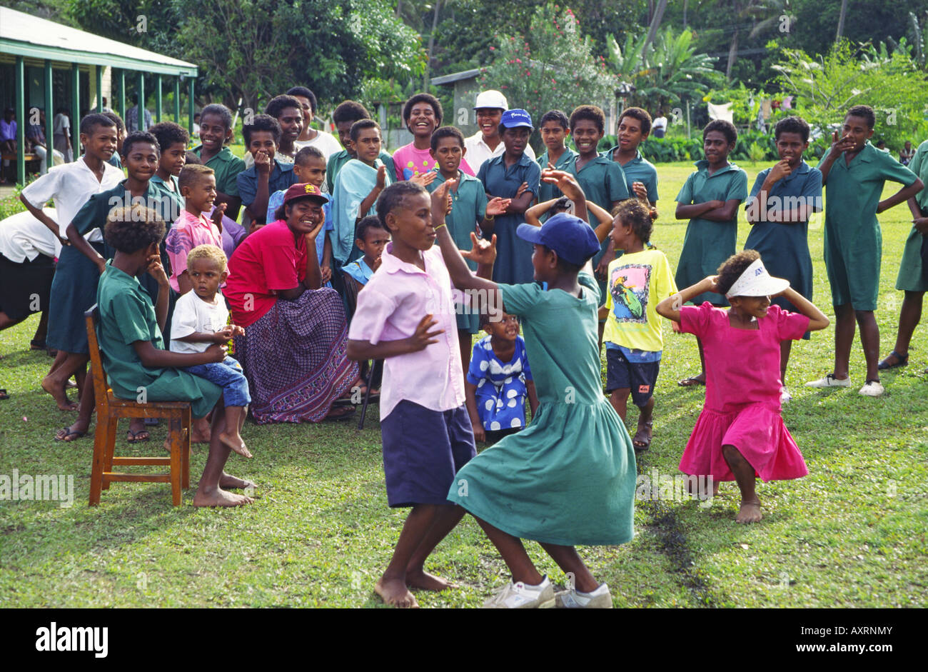 South Pacific Fiji Vitu Levu school class, kids dancing and singing outdoors Stock Photo
