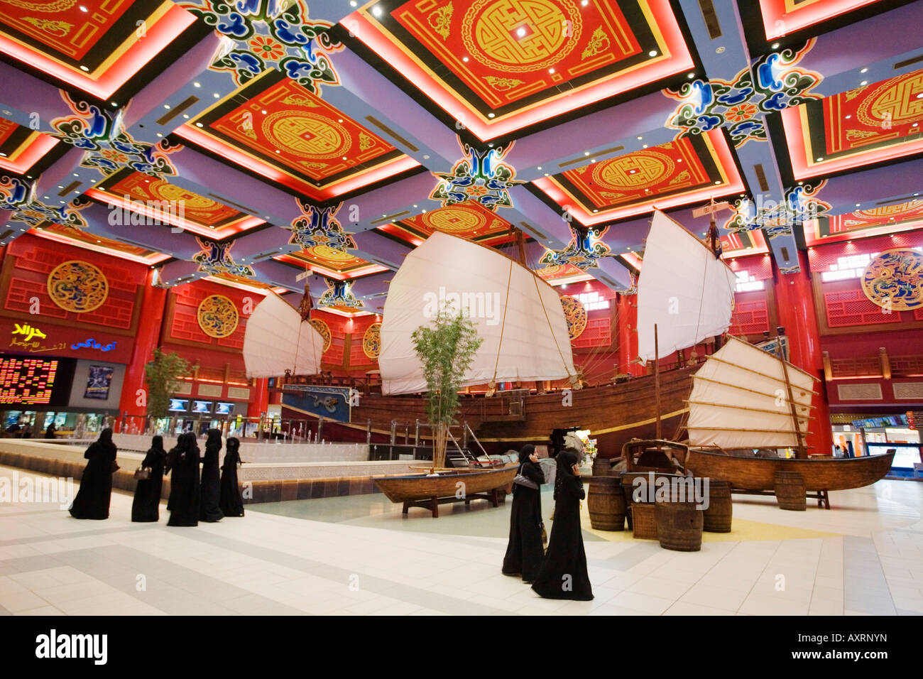Dubai Ibn Battuta Mall chinese decoration dhows arab sailing boats arab women veiled in black Abaya Stock Photo
