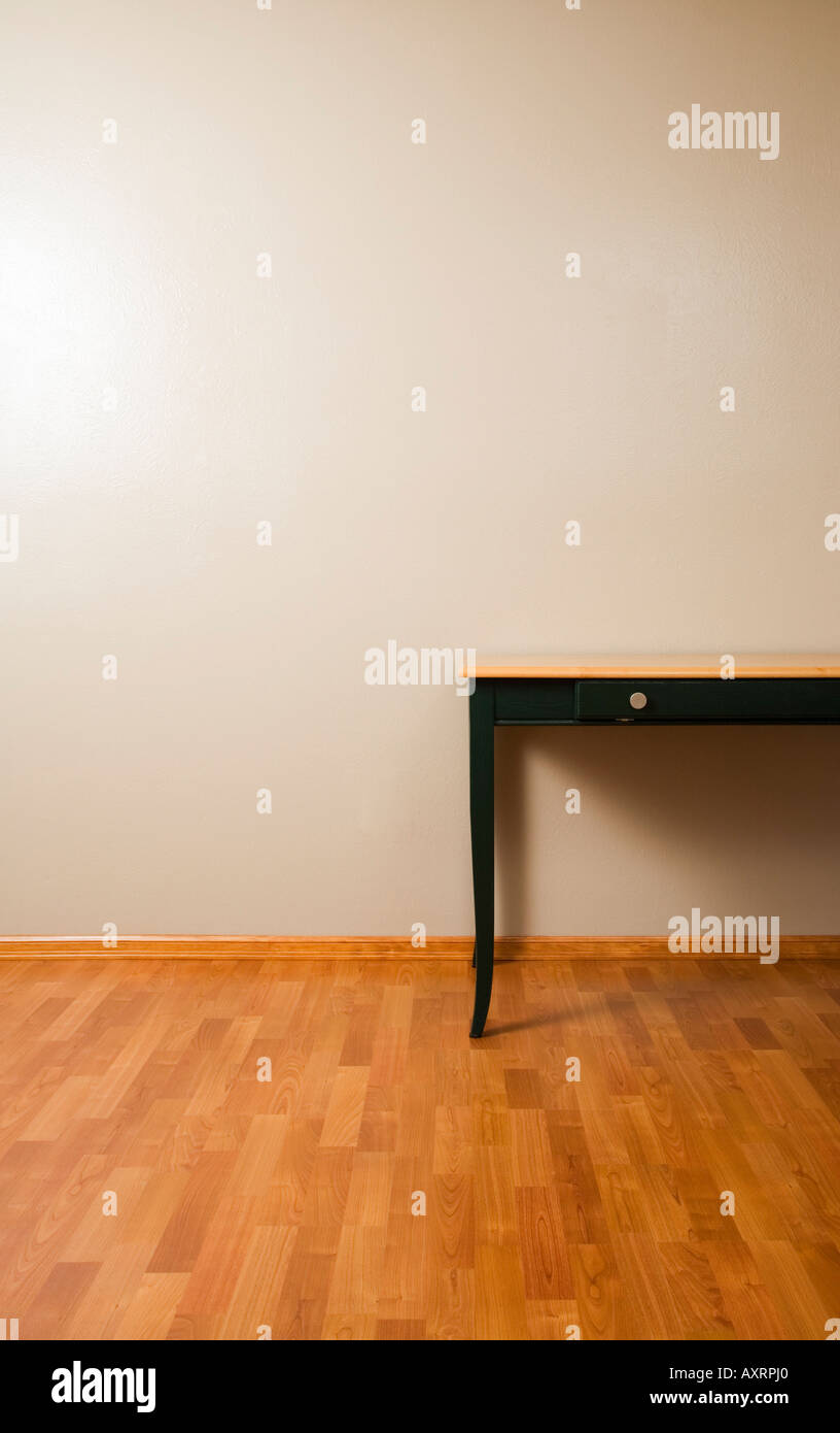 Table on hardwood floor Stock Photo - Alamy