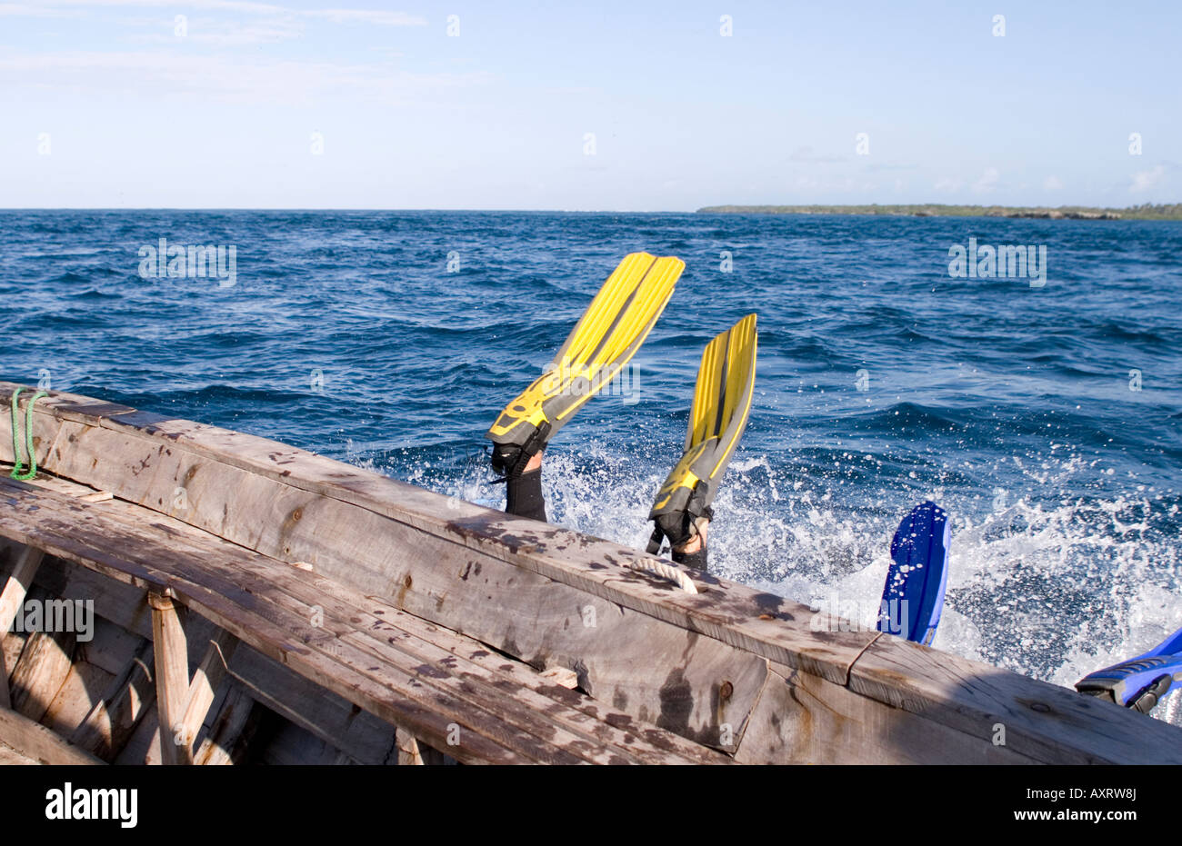 Scuba divers entering the water from a boat in Chole Bay Mafia Island