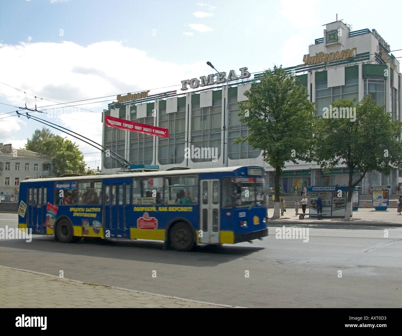 Trolleybus with spring-loaded trolley poles connecting with overhead wires in transit opposite Gomel shopping mall, Sovetskaya Street, Gomel, Belarus Stock Photo