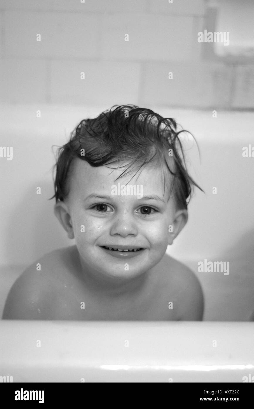 Small Child in Tub Boy with wet hair Stock Photo