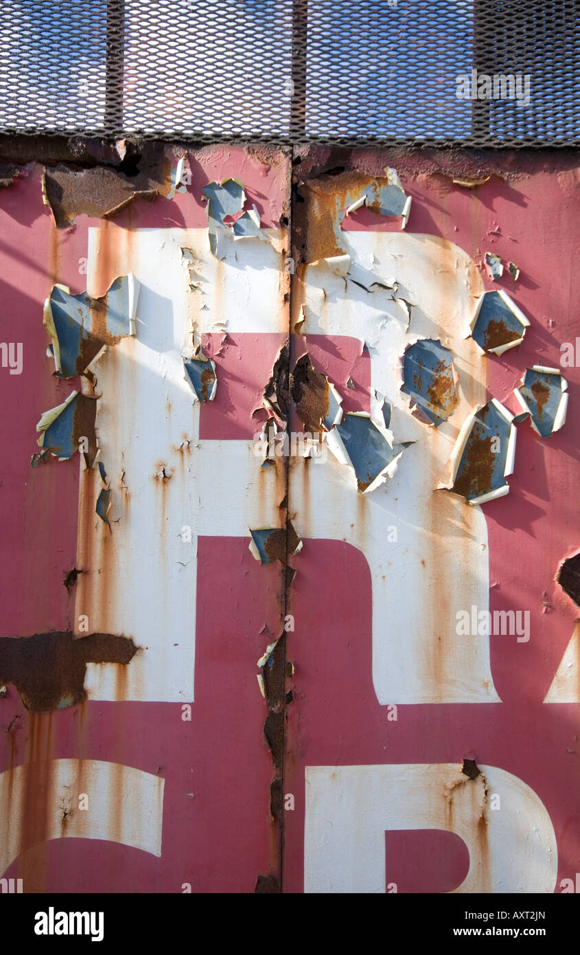 Peeling letter R on rusting disused scrap yard gates. Use for drop caps with text, illuminated letter, monogram, indexing etc. Stock Photo