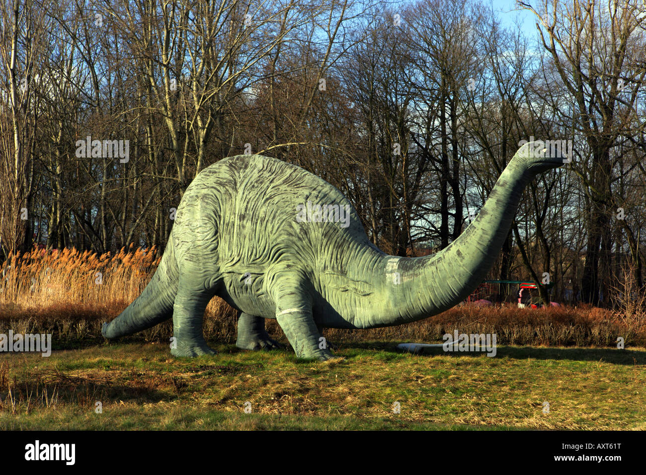 a plastic made dinosaur alone in the forest Stock Photo