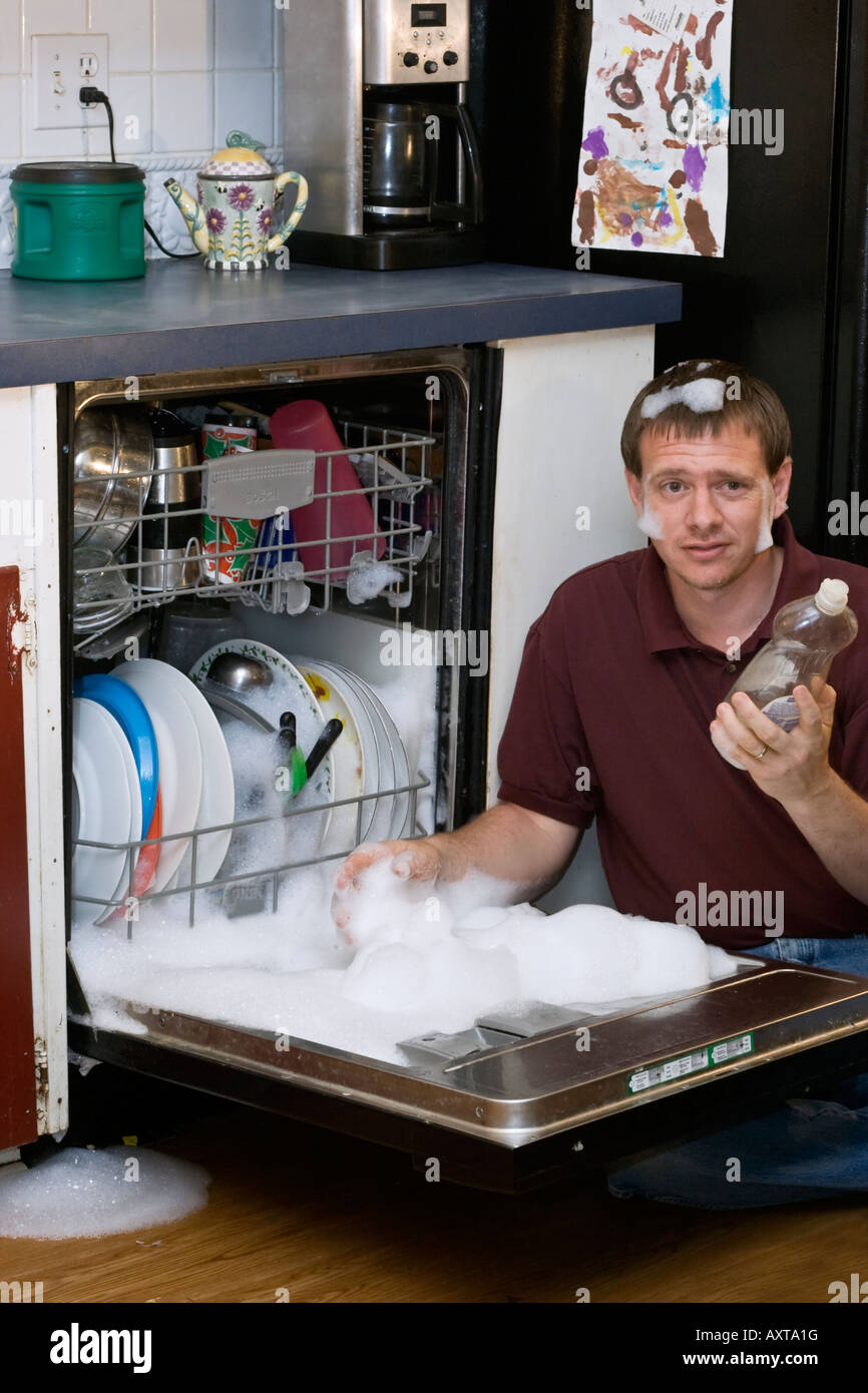Husband washing dishes with wrong soap Stock Photo Alamy