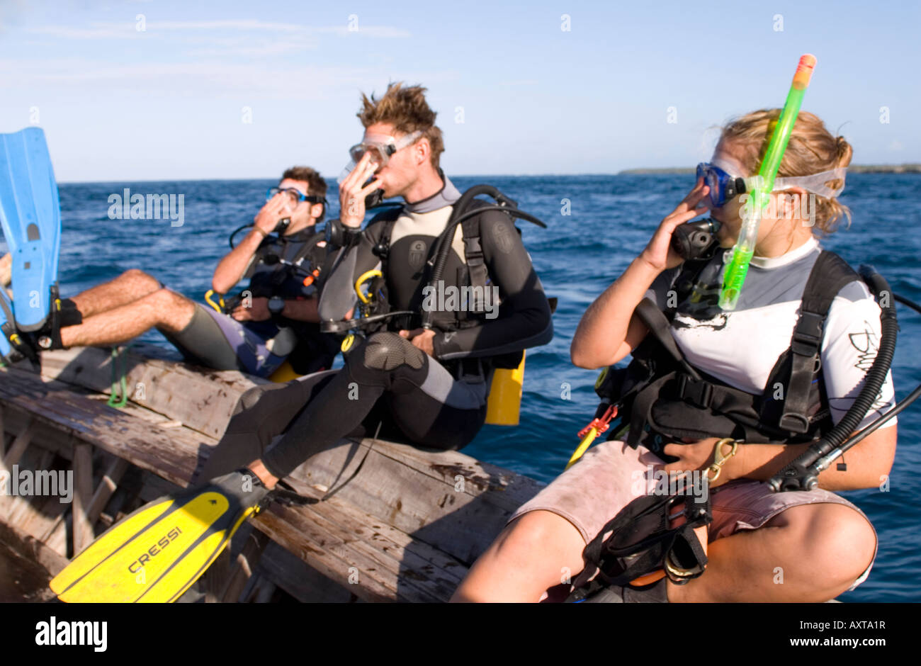 Scuba divers entering the water from a boat in Chole Bay Mafia Island