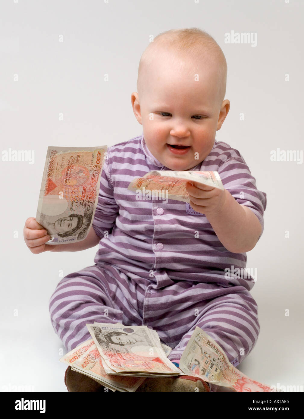 11 month old baby holding 50 fifty pound notes Stock Photo Alamy