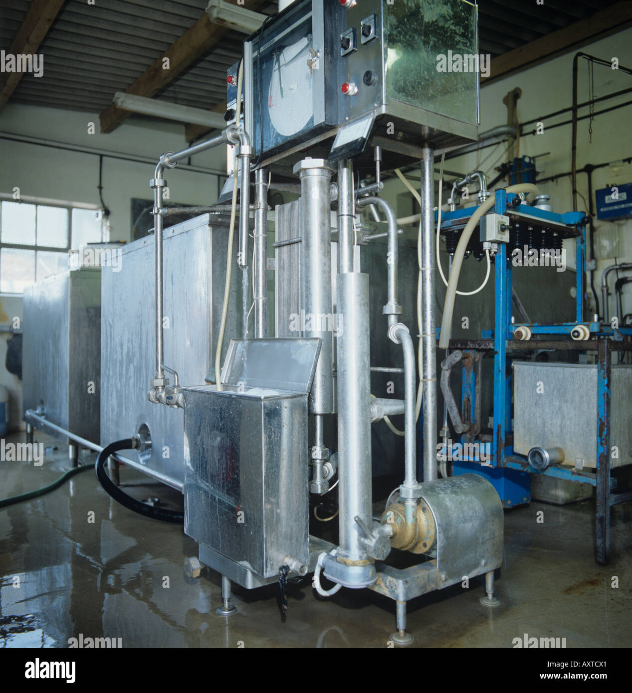 Milk bulk tanks pasteurizing machinery on farm bottling plant Stock