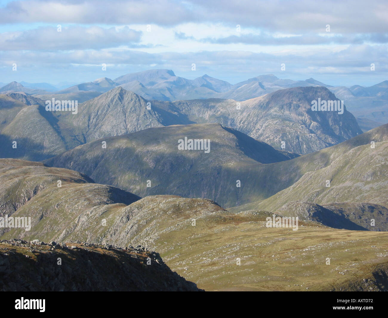 View over Glencoe mountains to Ben Nevis from Stob Ghabhar summit in Scotland Stock Photo