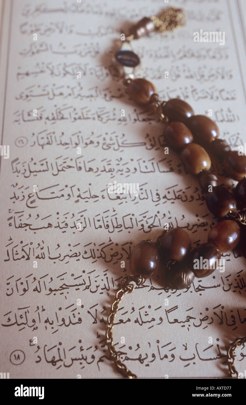 Prayer beads and arabic script of the Koran Stock Photo