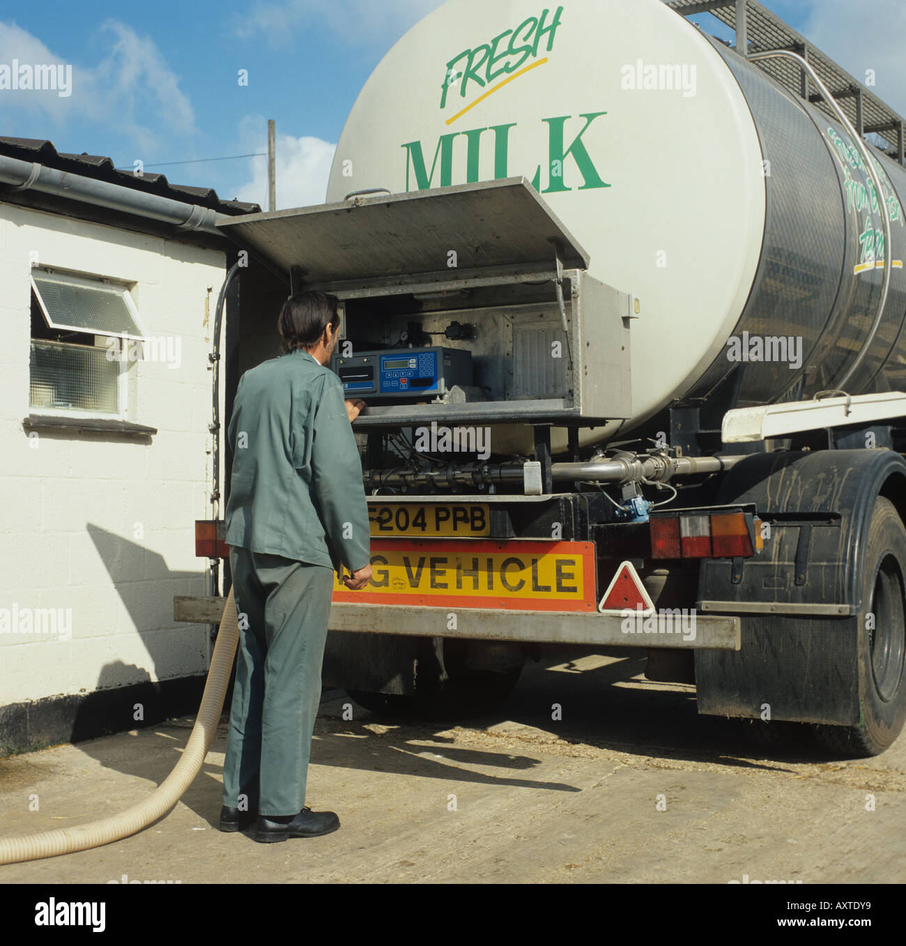 Milk tanker collecting fresh milk from farm dairy Hampshire Stock Photo