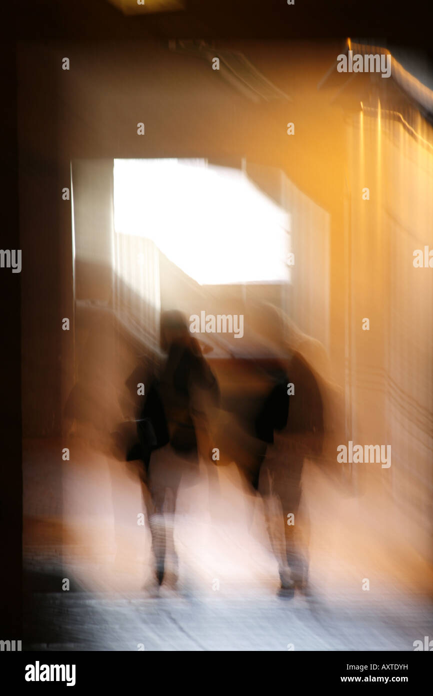 abstract two people walking in dark corridor at night Stock Photo