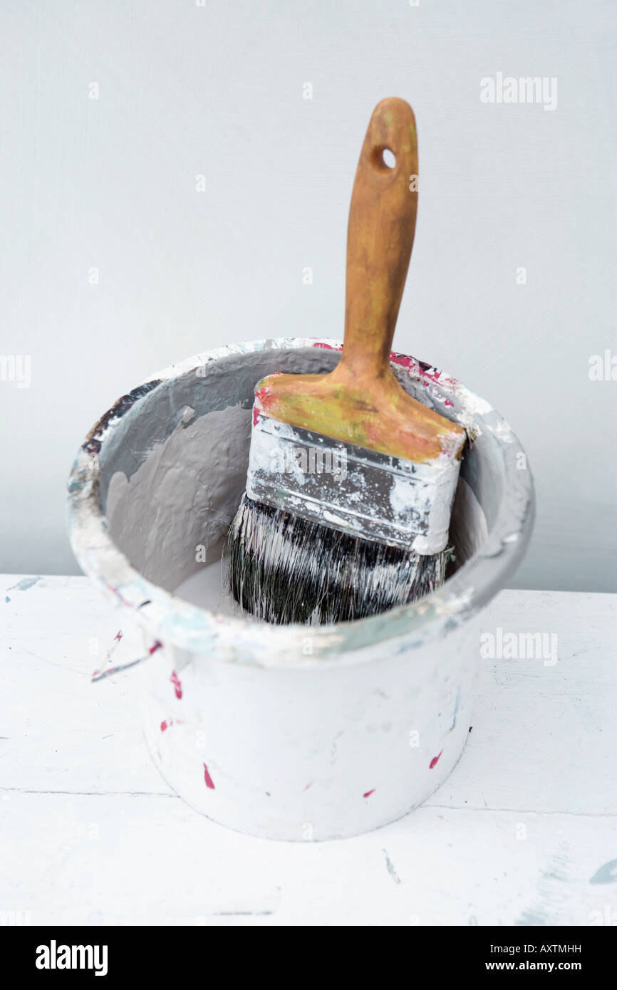 Old used paintbrush in a paint kettle Stock Photo Alamy