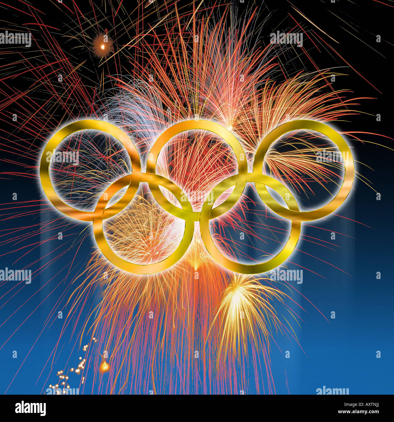 Golden olympic rings against fireworks over deep blue gradated background Stock Photo