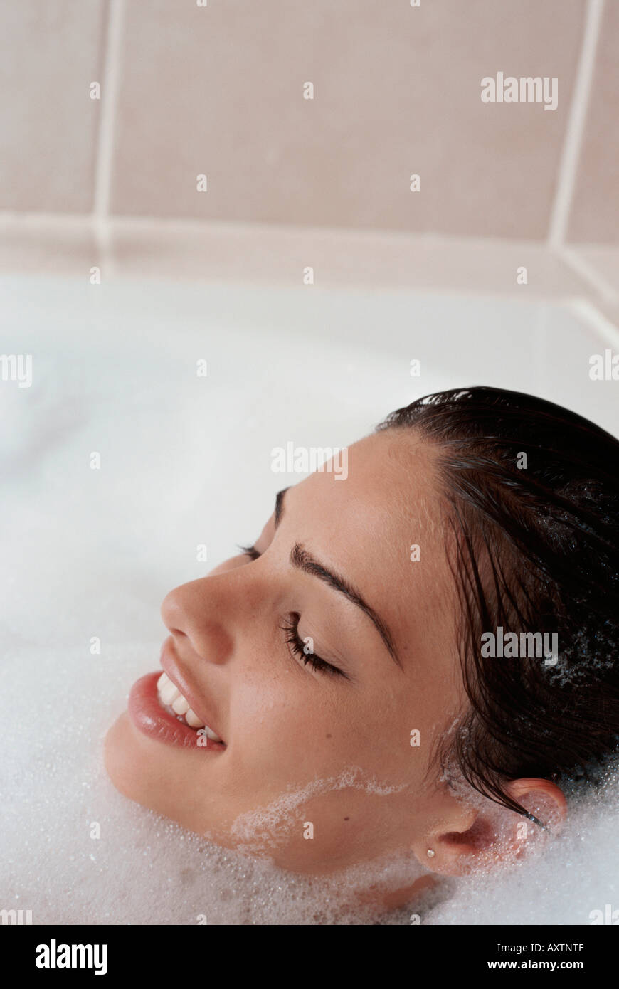 Woman washing hair bubble bath water bathroom hires stock photography