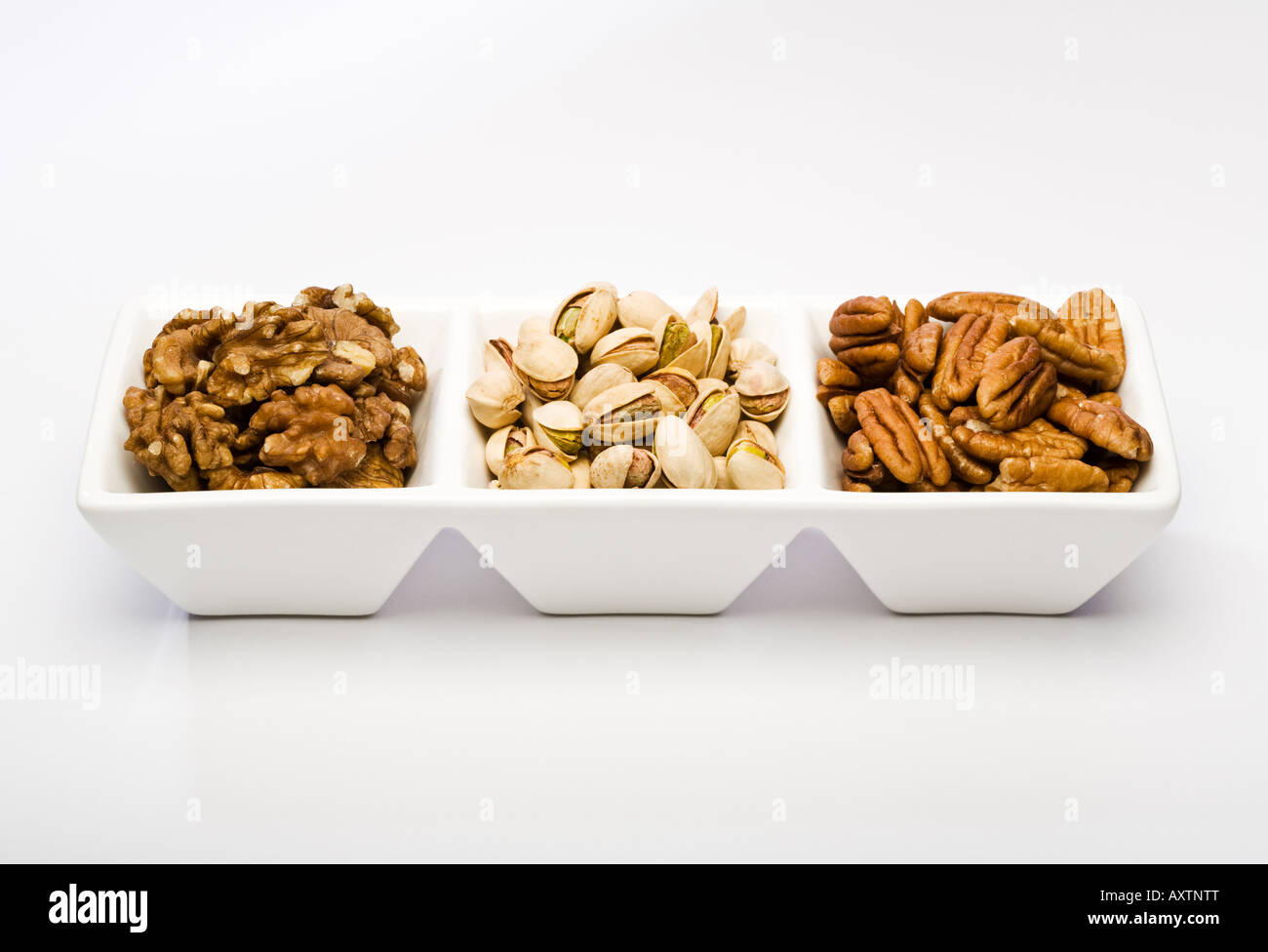 Three types of nut kernel Shelled Walnuts Pistachios and Pecans Stock Photo