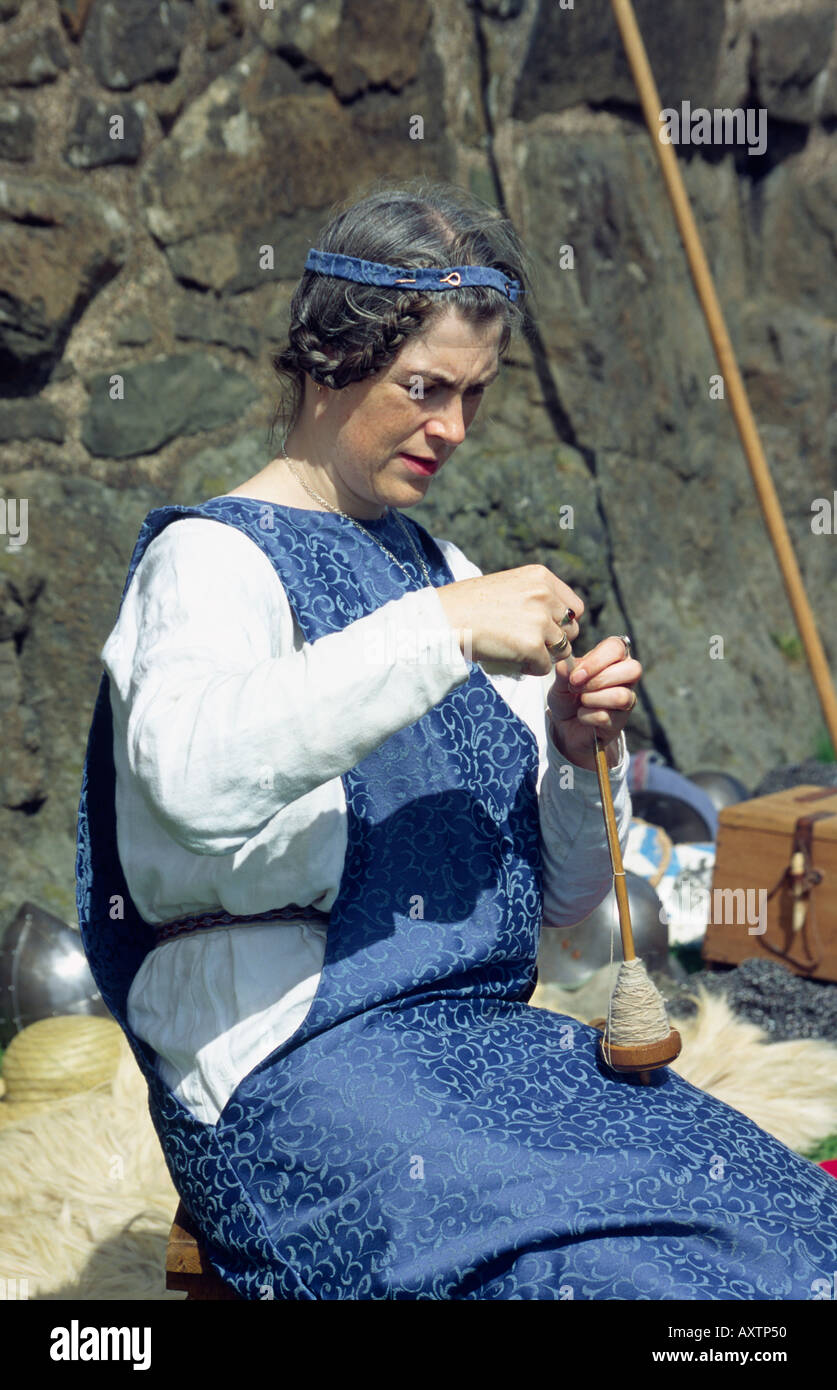 Woman spinning wool at an historical reenactment Stock Photo